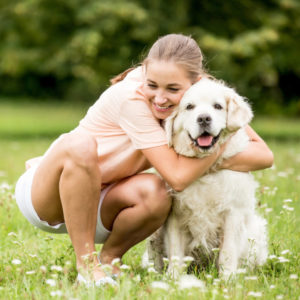 golden retriever and girl hugging and having fun outside dog groomer