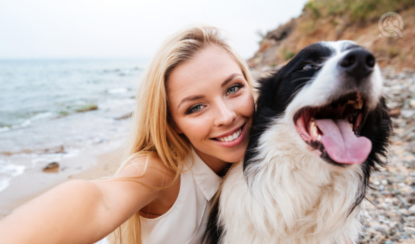 dog owner taking selfie with her groomed dog